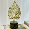 golden leaf decor, round marble base, table sculpture, modern home accent, minimal decor piece, single leaf stand, decorative showpiece, nicdecor.com, nichomedecor