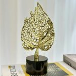 golden leaf decor, round marble base, table sculpture, modern home accent, minimal decor piece, single leaf stand, decorative showpiece, nicdecor.com, nichomedecor